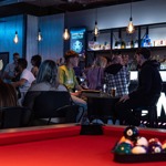 Pool table with the balls racked up at Boom Battle Bar.