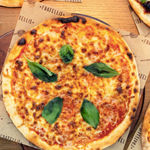 Three pizzas on a table.