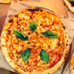 Three pizzas on a table.