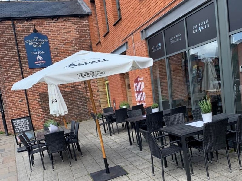 Outdoor tables at the Chop Shop Bar & Grill.