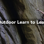 A man climbing a rocky outcrop in a wood. Over the image are the words 'Outdoor Learn To Lead'.