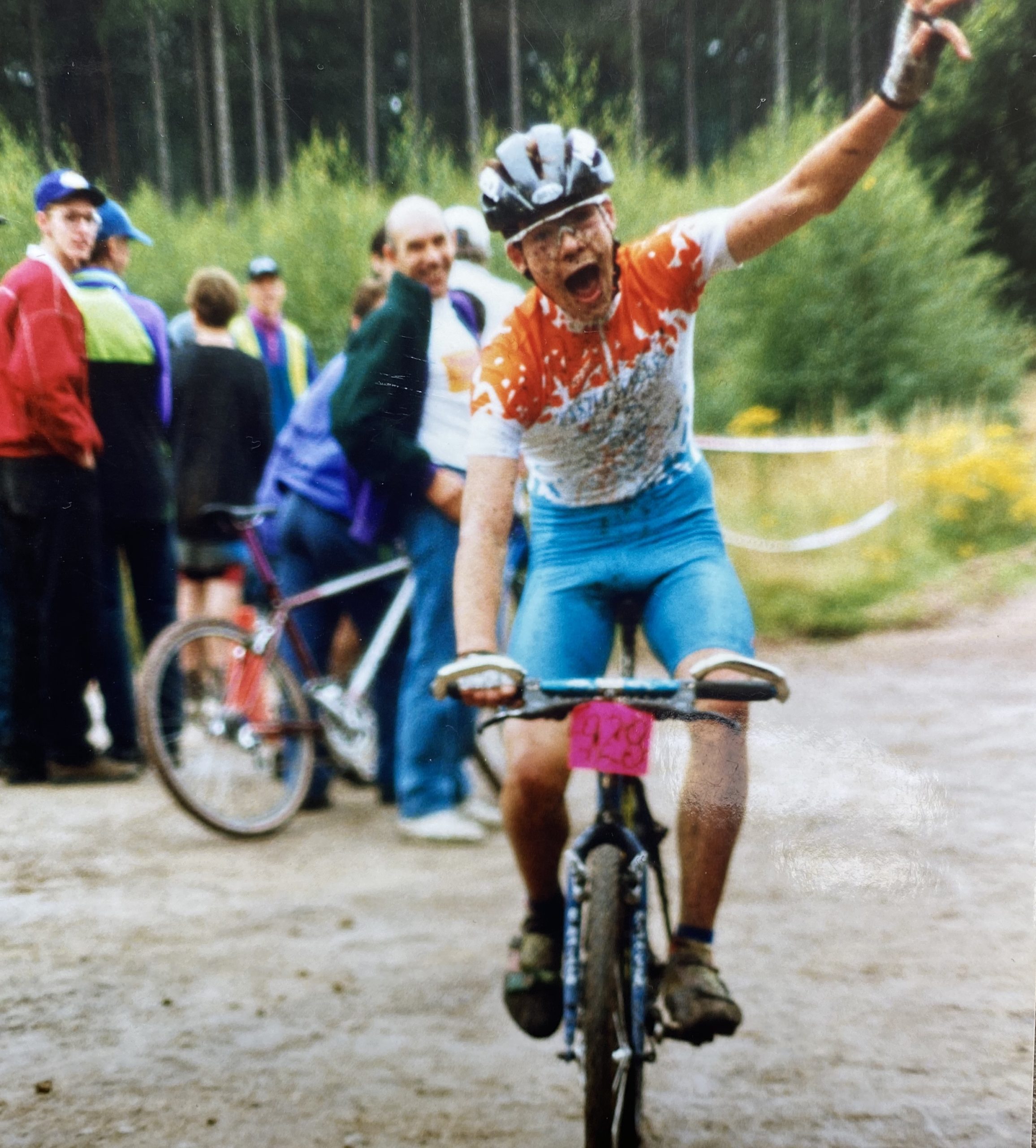 A person elated to have finished a bike race.