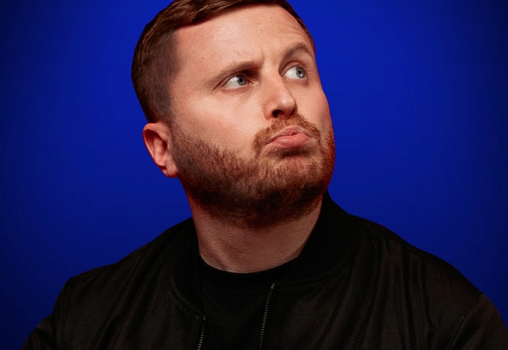 A head-shot of Josh Baulf pursing his lips.