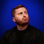 A head-shot of Josh Baulf pursing his lips.