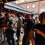 A group of people dancing at a night out.
