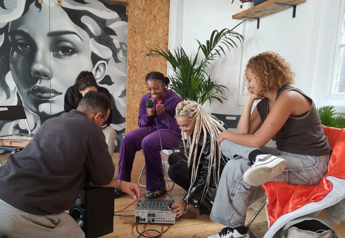 People sat around a mixing deck.