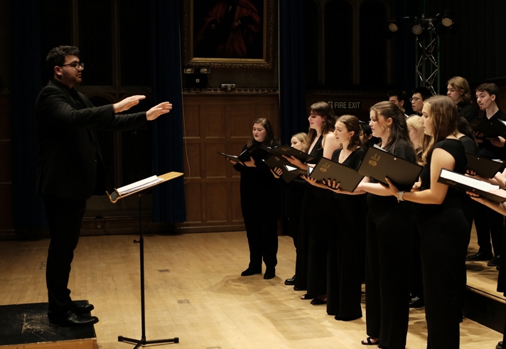 A choirs performs with a conductor. 