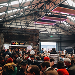 Peddler Market & Warehouse full of people sitting at long tables.