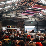Peddler Market & Warehouse full of people sitting at long tables.