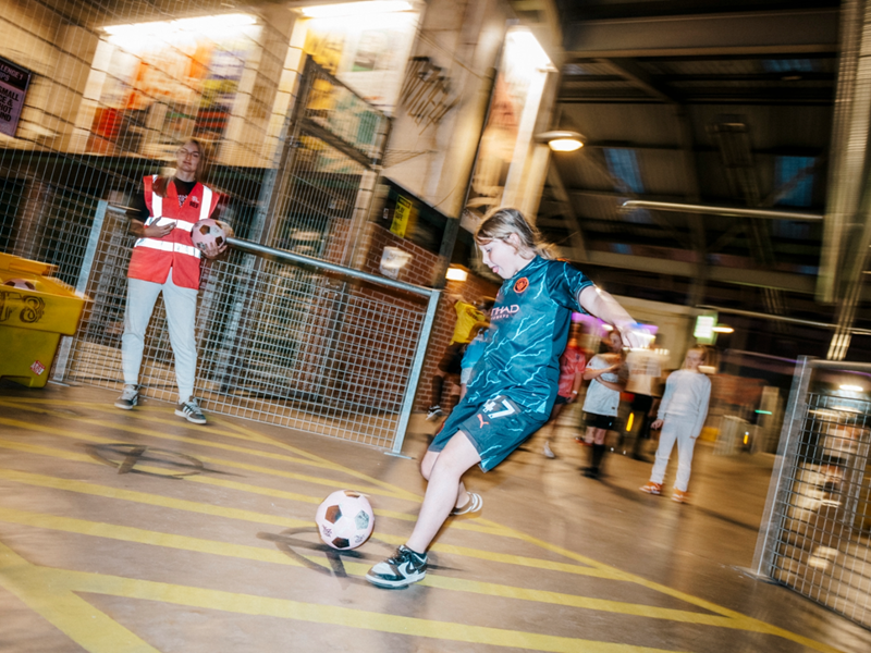 Children playing football at Yard Ball, an indoor football park.