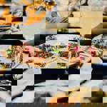 Plates of various different dishes arranged on a table.