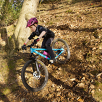 People mountain biking in the countryside.