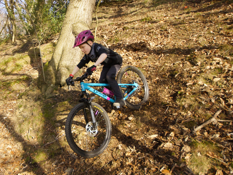 People mountain biking in the countryside.