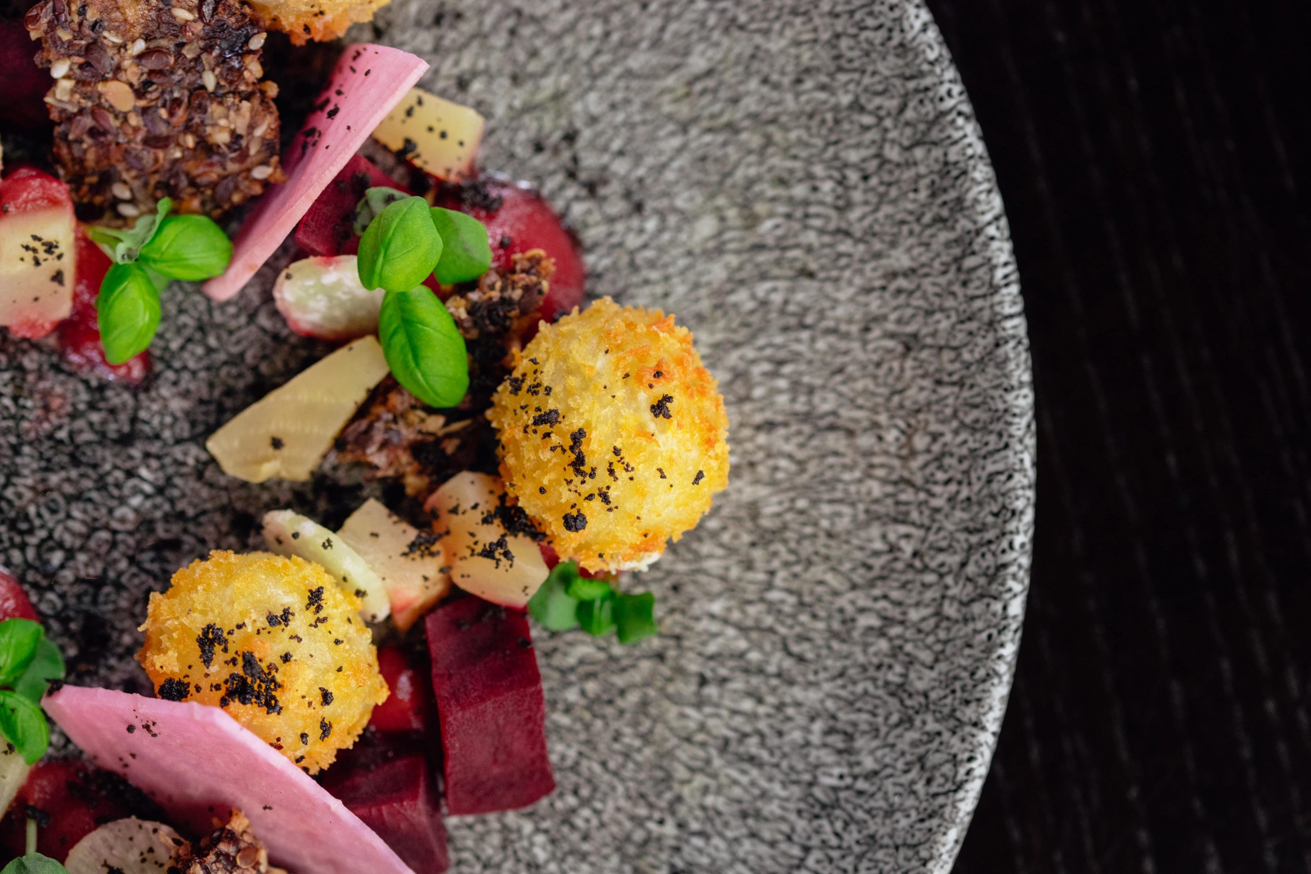 Food on a grey speckled plate.
