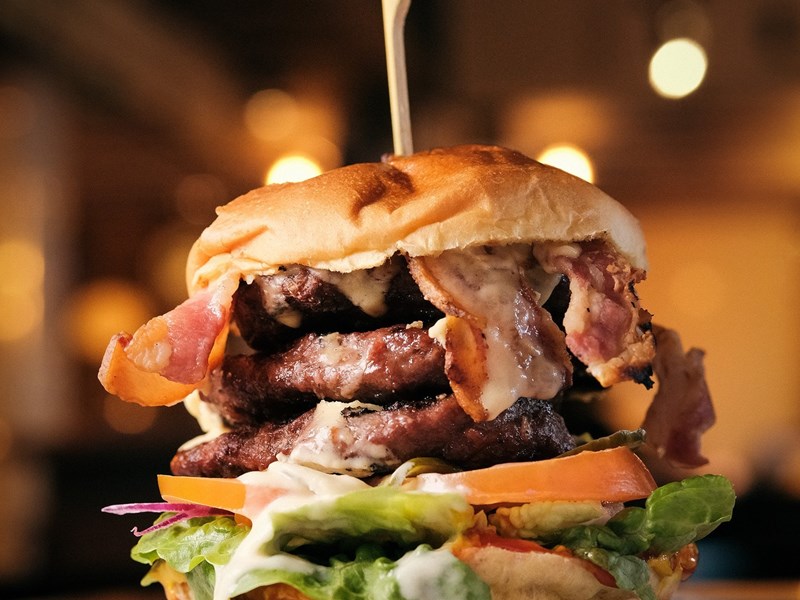 A double patty cheese burger with bacon.