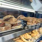 a close up of some of the filled croissants in a glass display