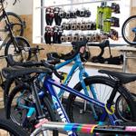 The interior of a shop filled with bikes and cycling equipment on display.