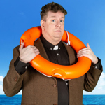 A person, dressed as a vicar, holds an orange life preserver round their neck.