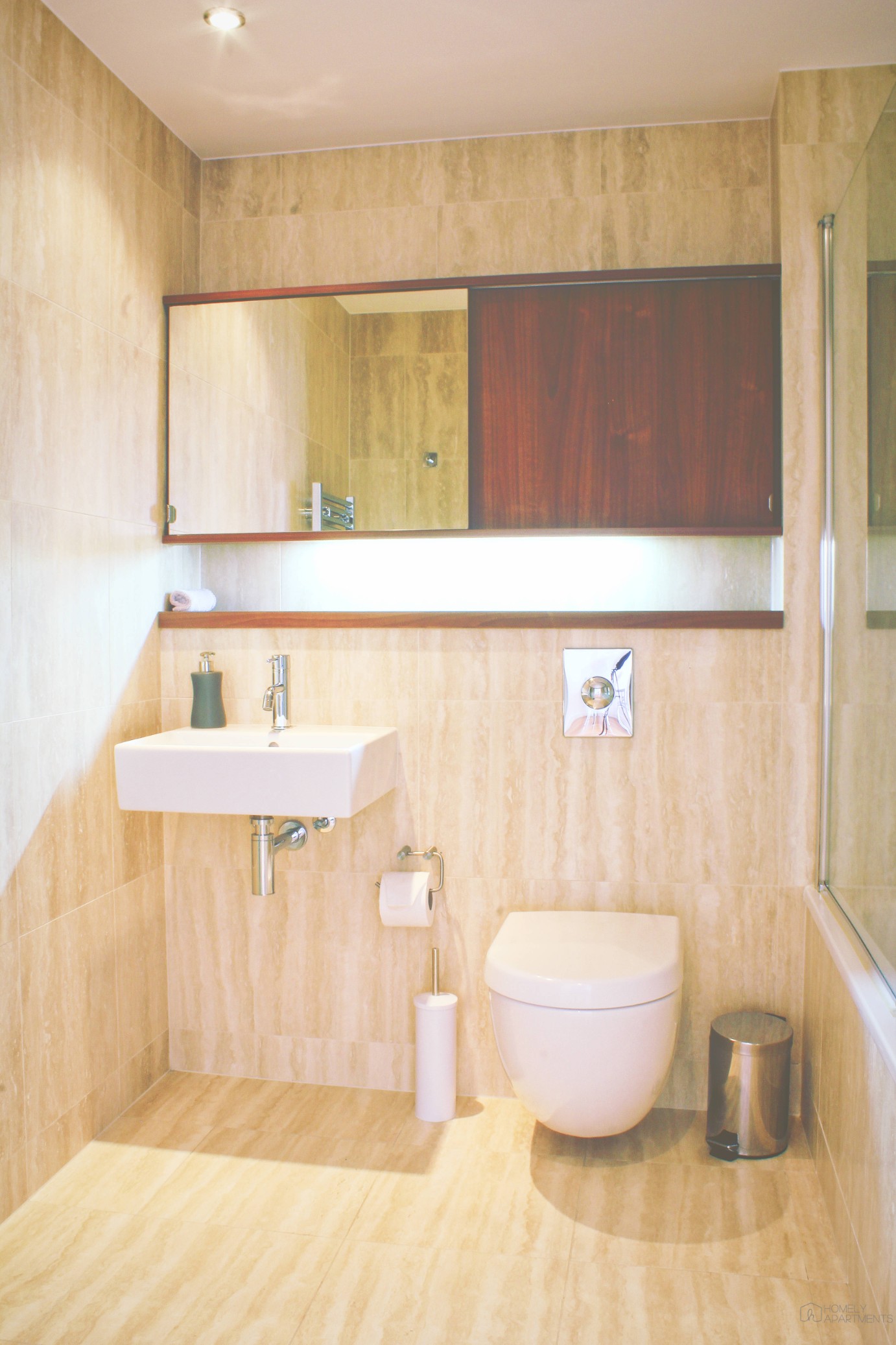 Bathroom at Homely Serviced Apartments – St. Paul’s with sink and mirror.