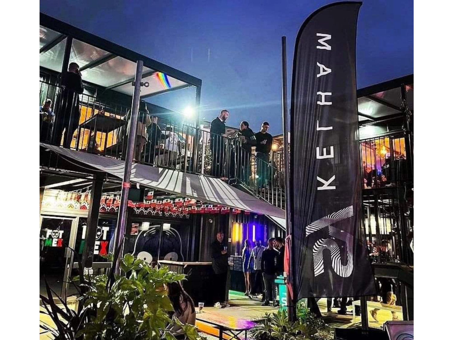 SYSheffield lit up in the evening, full of people having a night out.