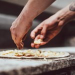 A pizza being prepaired.