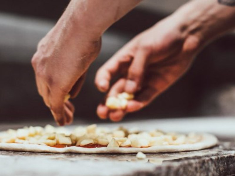 A pizza being prepaired.