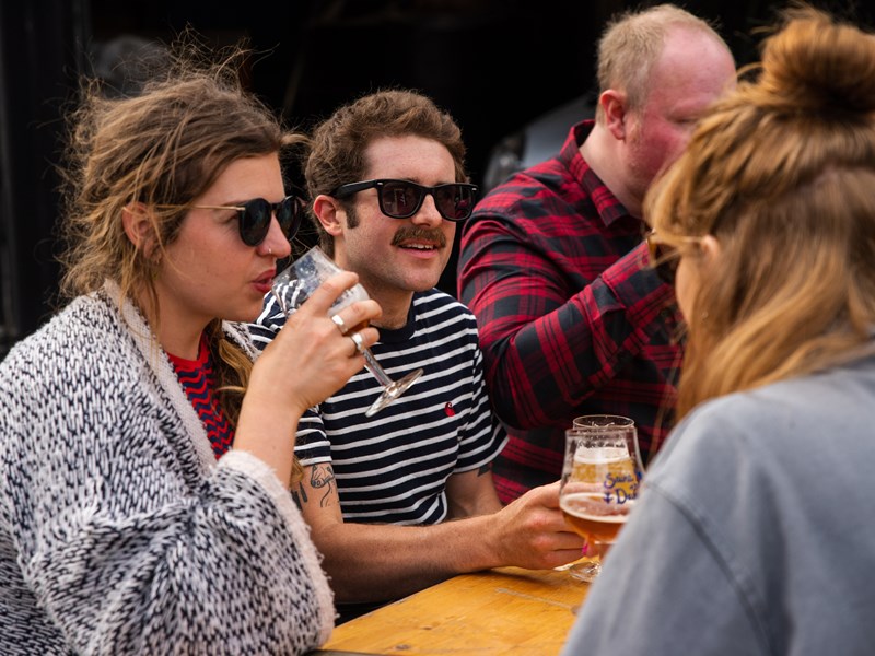 People enjoying a beer outdoors at The Brewery of St Mars of the Desert.