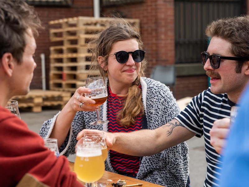 People enjoying a beer at The Brewery of St Mars of the Desert.