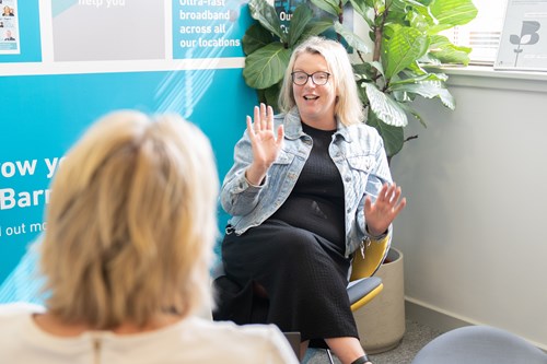 A picture of Zoe Wadsworth speaking with a client