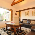 Bright living room featuring a large window with natural light, sofa, and coffee table.