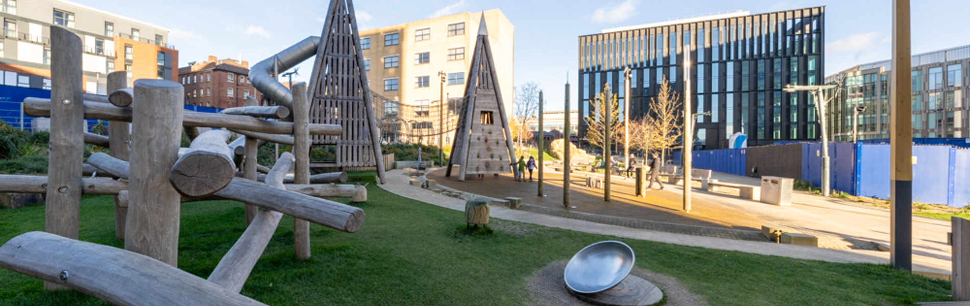 A view across Pound's Park, showing the play equipment and beches.