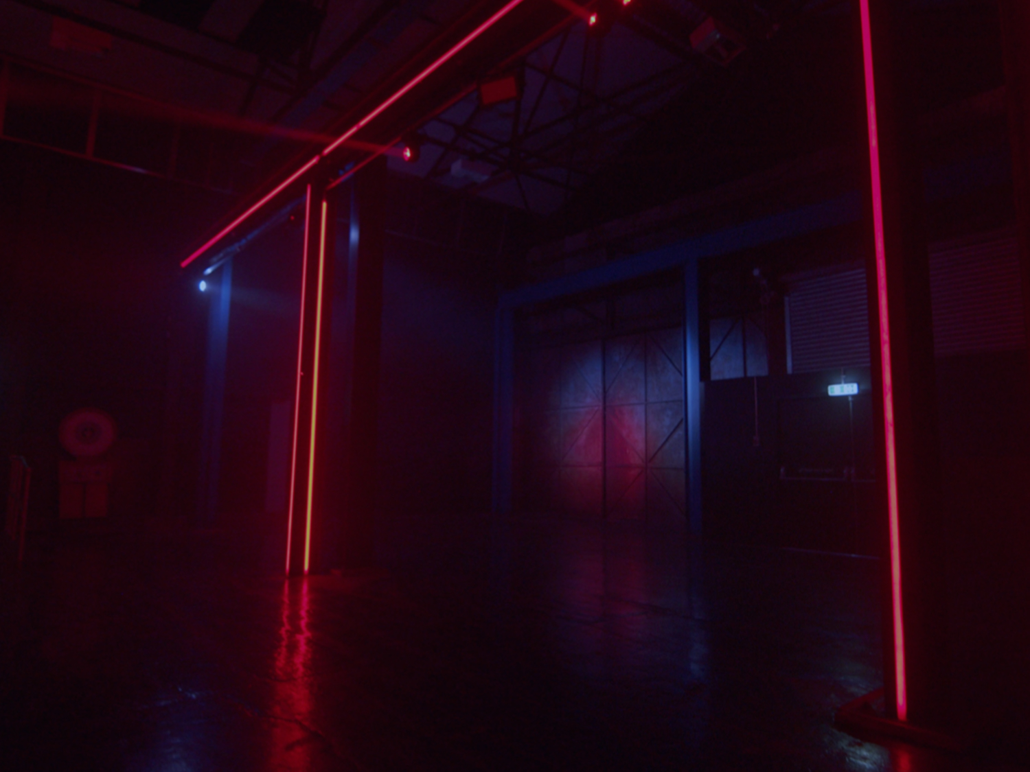 The interior of FØRGE with red neon lights glowing in the darkness.