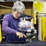A woman making Buffalo Systems clothing.