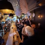 The interior of a lively and packed bar.