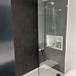 Bathroom with a large shower and a glass partition.