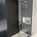 Bathroom with a large shower and a glass partition.