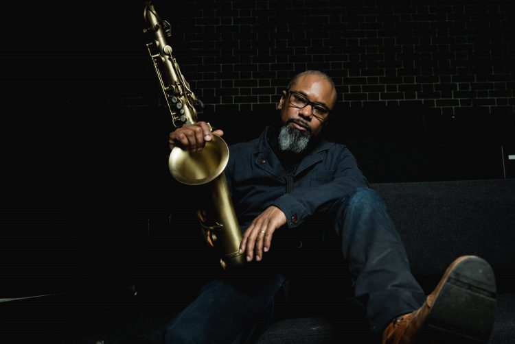 Denys Baptiste posing with his saxaphone.