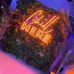 An orange neon sign that reads 'Chill here', on the wall at Sheffield Plate.