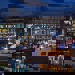 The canal basin and surrounding buildings lit up at night at Victoria Quays.