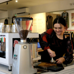 A woman making coffee.