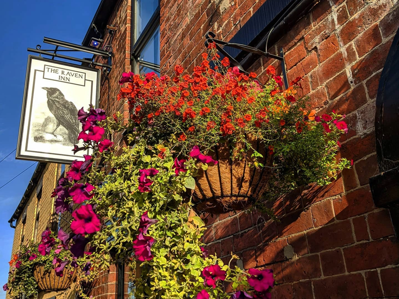 The sign hanging outside the Raven Inn.