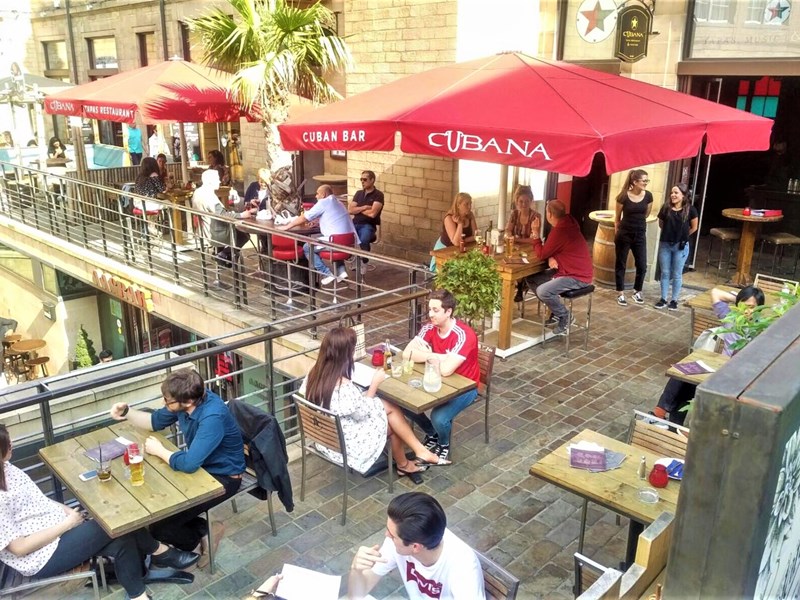 People eating on the terrace at Leopold Square.