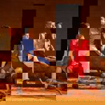 Four actors performing on a stage.