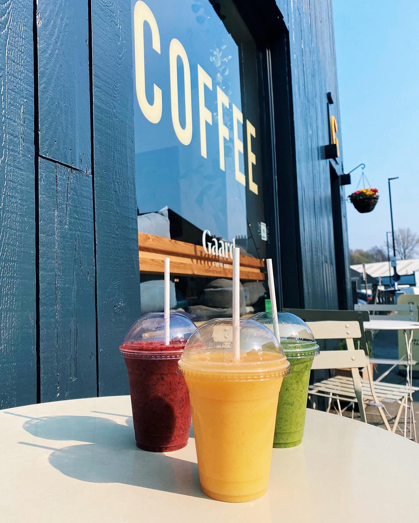 Three smoothies on a table outside Gaard Coffee Hide.