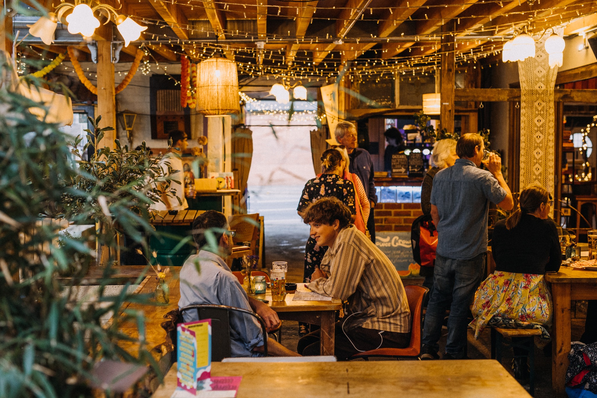 The inside of Hagglers Corner, where people are sat at tales dining.