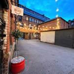 The exterior of Lovely Rita's Bakehouse at night, lit up by strings of lights.