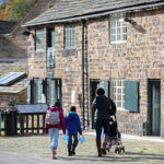 A family looking around the Abbeydale Industrial Hamlet.