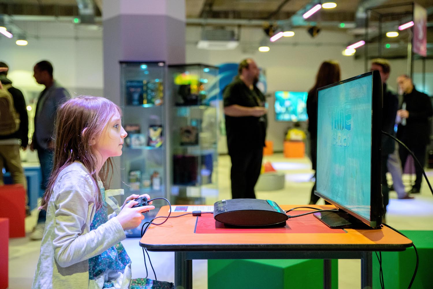 A child is sat playing a retro video games console at the National Video Games Museum.