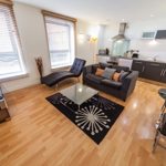Interior of a living area with seating, a coffee table, and décor, creating a comfortable and inviting space.