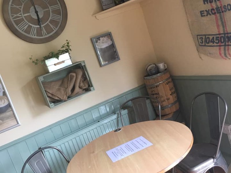 A cosy table in the corner of Millhouses Park Cafe.